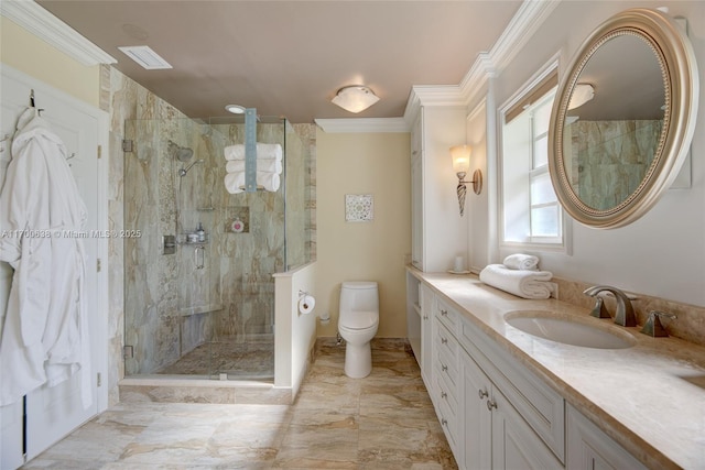 bathroom with a shower with door, crown molding, vanity, and toilet