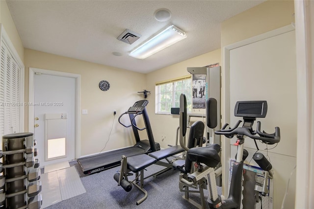 workout area with a textured ceiling