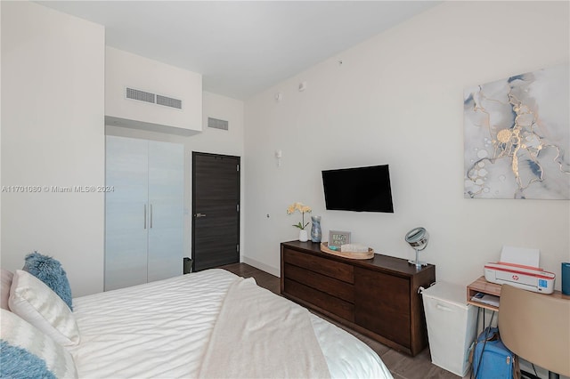 bedroom with wood-type flooring and a closet