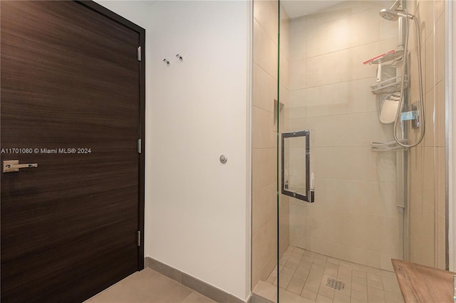 bathroom featuring tile patterned flooring and a shower with shower door