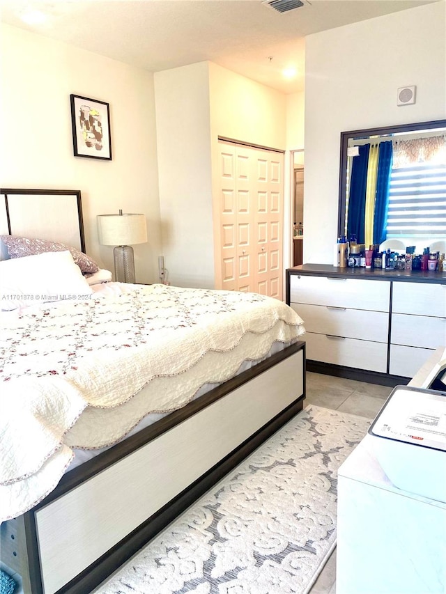 tiled bedroom with a closet