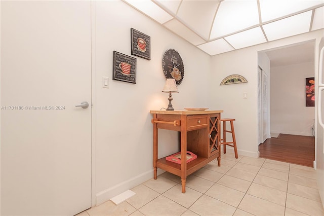 corridor featuring light tile patterned floors