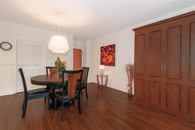 dining space featuring dark wood-type flooring