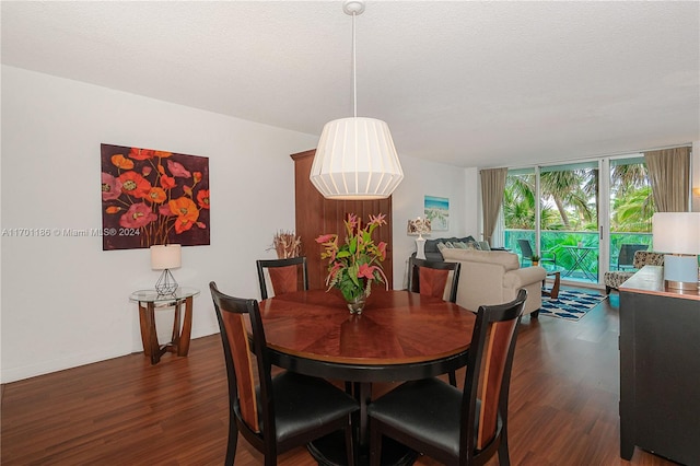 dining area featuring a textured ceiling and dark hardwood / wood-style flooring