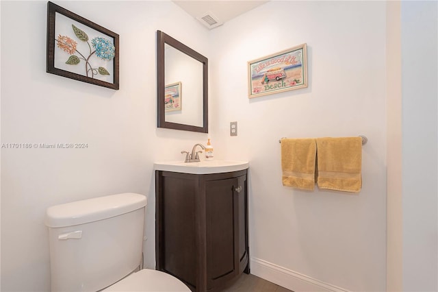 bathroom featuring vanity and toilet