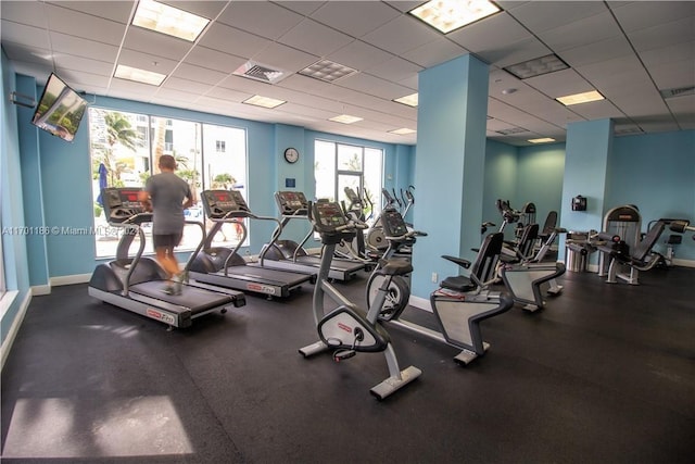 exercise room featuring a paneled ceiling