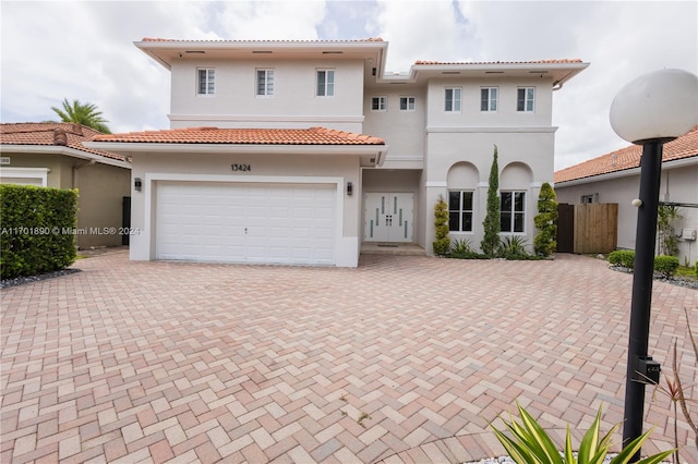 mediterranean / spanish home with a garage