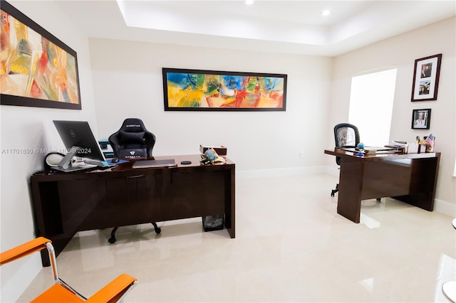 office area with a tray ceiling