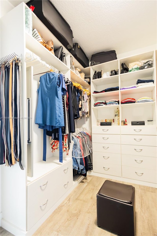 walk in closet featuring light hardwood / wood-style flooring