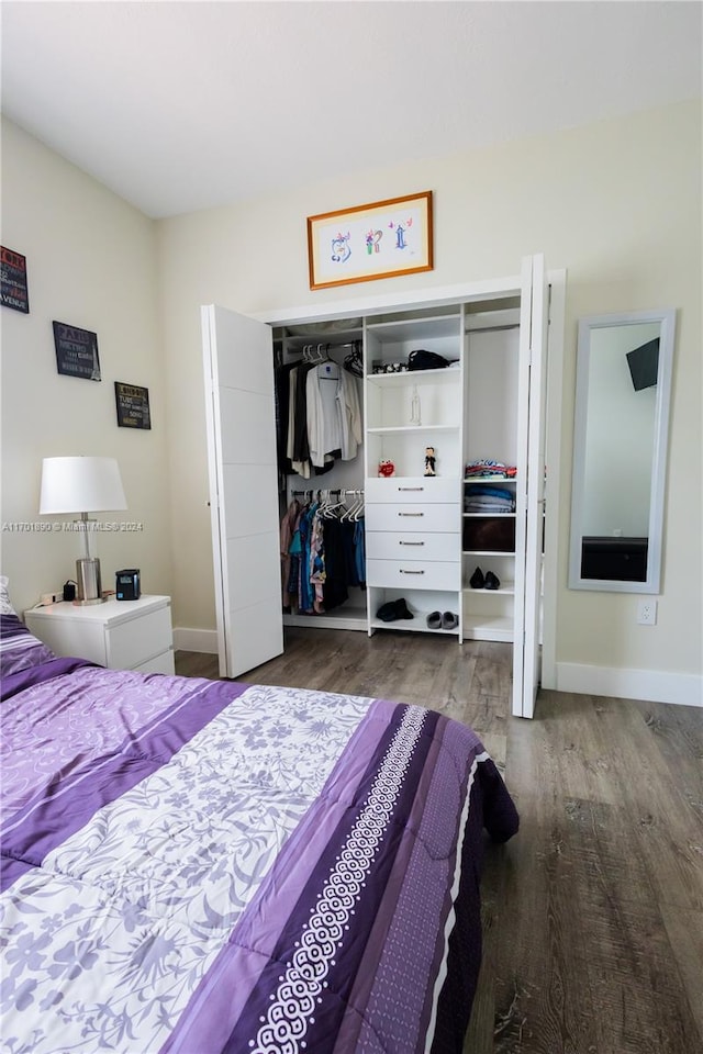 bedroom featuring hardwood / wood-style floors and a closet