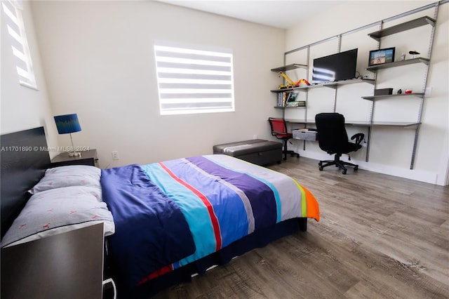 bedroom with dark wood-type flooring