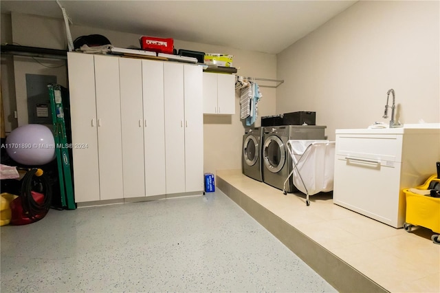 garage with washing machine and clothes dryer and sink