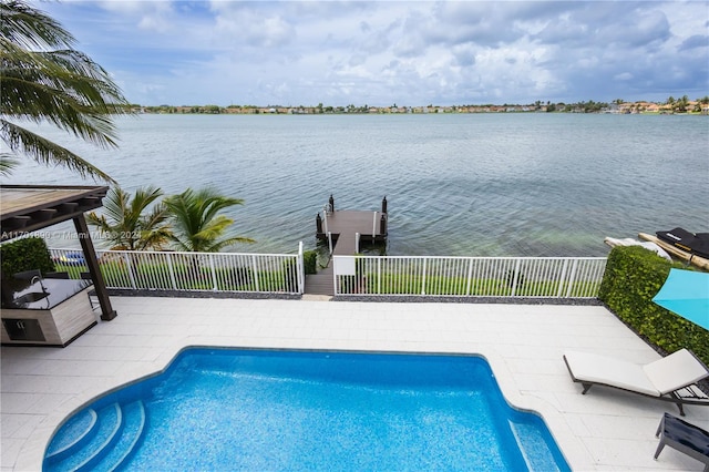 view of pool with a patio area and a water view