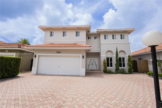 mediterranean / spanish-style house with a garage