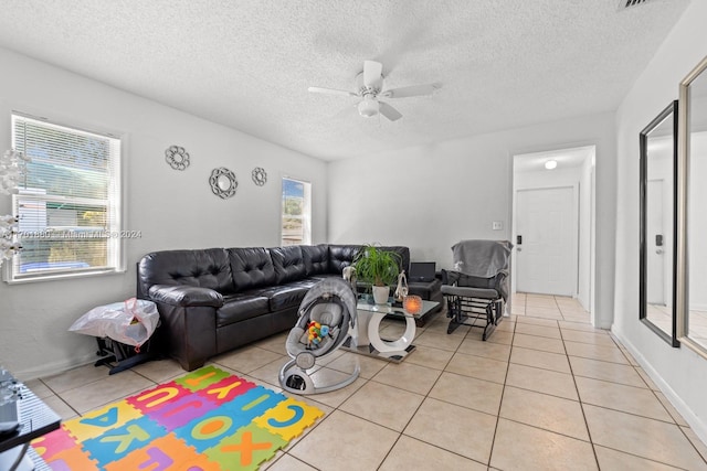 tiled living room featuring a textured ceiling and ceiling fan