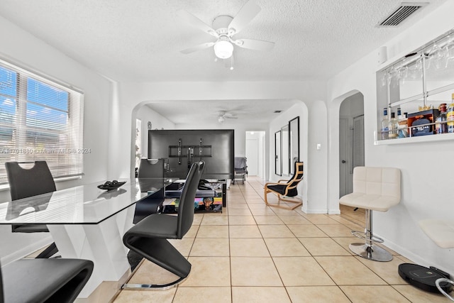 interior space with a textured ceiling and ceiling fan