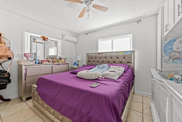 tiled bedroom with an AC wall unit, ceiling fan, and a textured ceiling