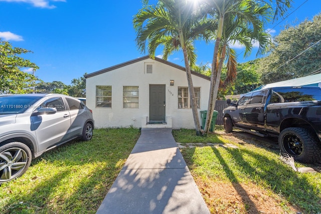 bungalow-style house featuring a front yard