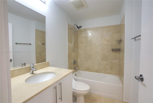 full bathroom featuring tile patterned flooring, vanity, toilet, and tiled shower / bath combo