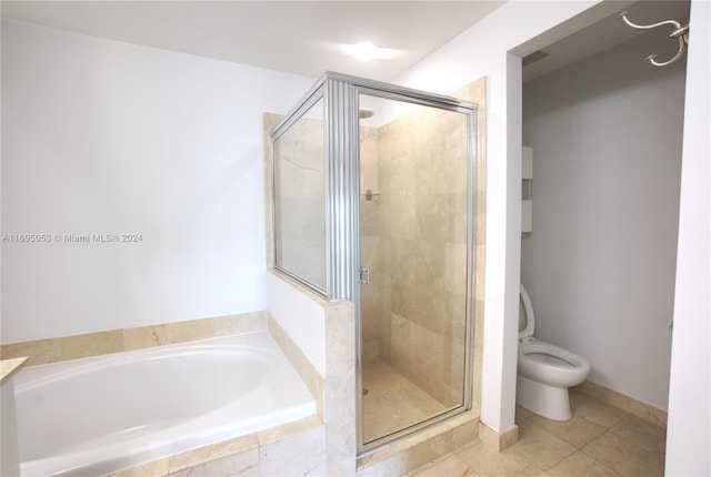 bathroom with tile patterned flooring, separate shower and tub, and toilet