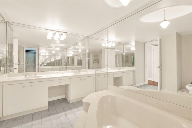 bathroom featuring a washtub and vanity