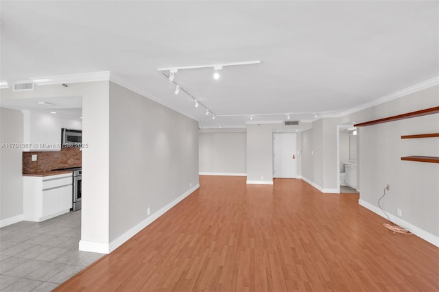 unfurnished living room featuring crown molding and light hardwood / wood-style floors