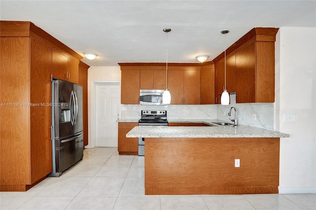 kitchen with kitchen peninsula, appliances with stainless steel finishes, backsplash, sink, and decorative light fixtures