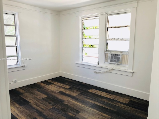 unfurnished room with cooling unit, dark hardwood / wood-style floors, and a wealth of natural light