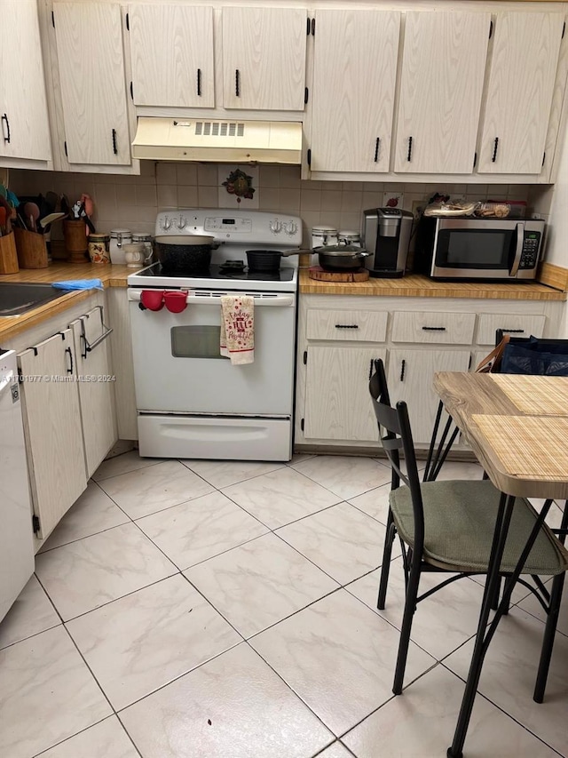 kitchen with white appliances and tasteful backsplash