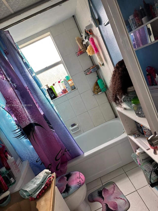 bathroom featuring tile patterned flooring, shower / bath combo, and toilet