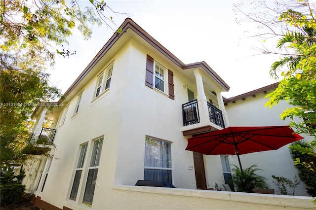 view of side of property with a balcony