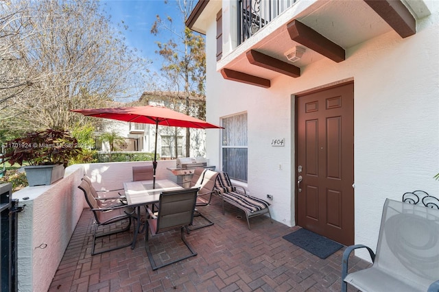 view of patio featuring a balcony