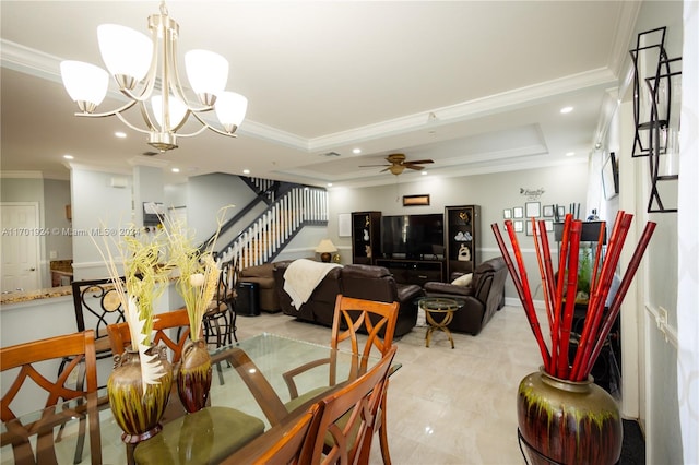 dining space featuring ceiling fan with notable chandelier, a raised ceiling, and ornamental molding