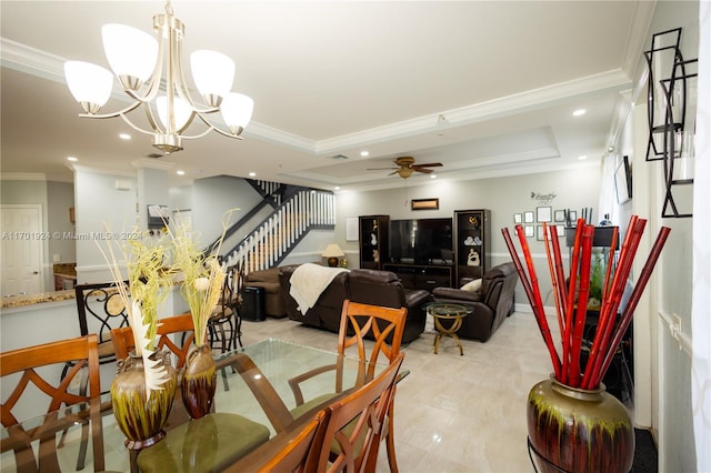 dining room featuring a tray ceiling, ceiling fan with notable chandelier, and ornamental molding