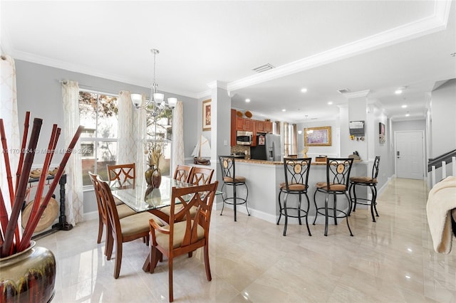 dining area with ornamental molding and a notable chandelier