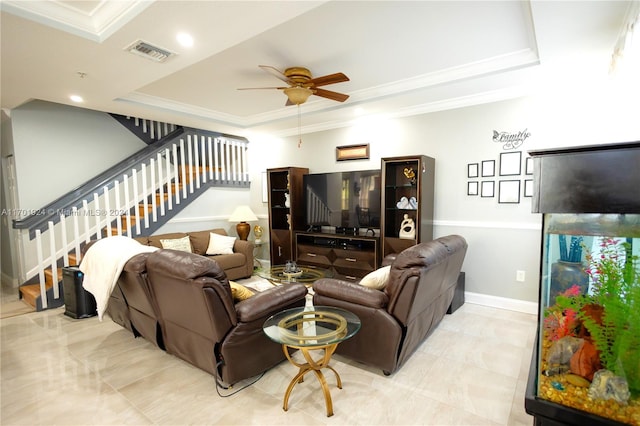 living room with ceiling fan, crown molding, and a tray ceiling