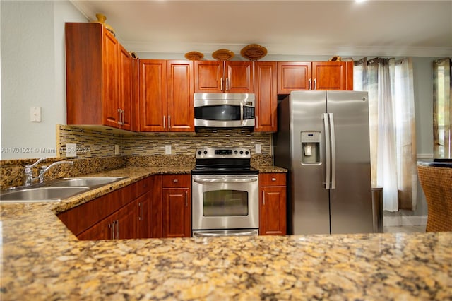 kitchen with sink, stainless steel appliances, backsplash, crown molding, and stone countertops