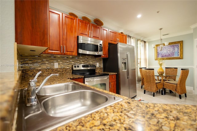 kitchen featuring pendant lighting, sink, decorative backsplash, appliances with stainless steel finishes, and a notable chandelier