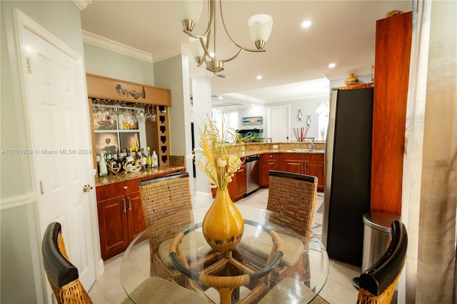 dining room with sink, a notable chandelier, and ornamental molding