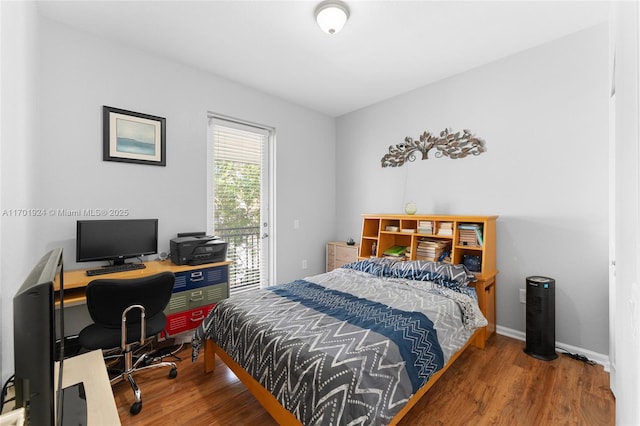 bedroom featuring hardwood / wood-style flooring and access to outside