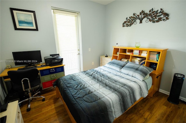 bedroom with dark hardwood / wood-style floors