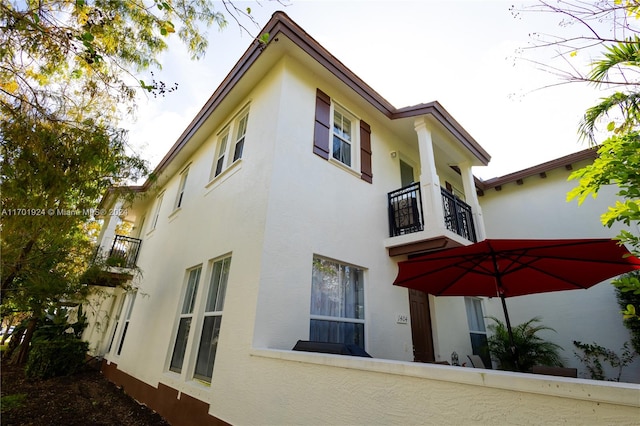 view of side of home featuring a balcony