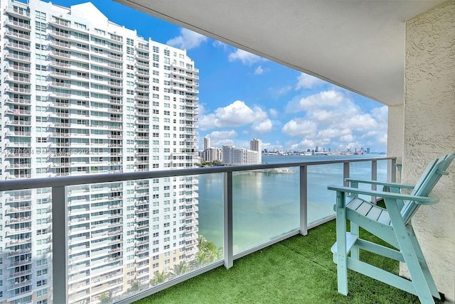 balcony with a view of city and a water view