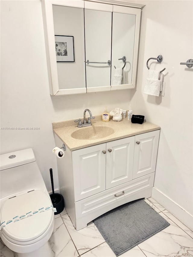 bathroom featuring vanity and toilet