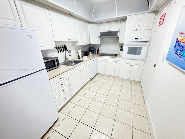 kitchen featuring tasteful backsplash, white appliances, sink, white cabinetry, and light tile patterned flooring