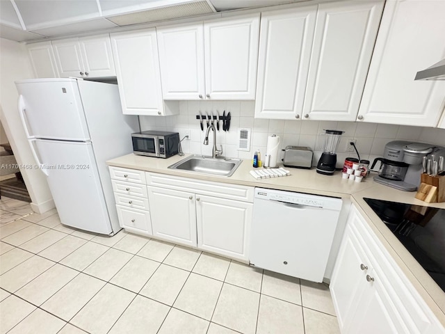 kitchen featuring decorative backsplash, sink, white cabinets, and white appliances