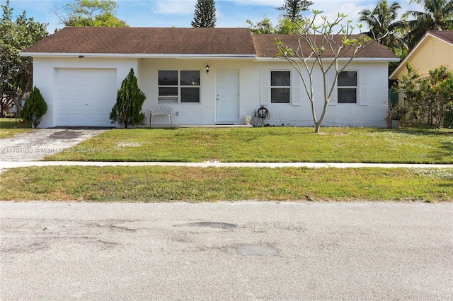 single story home featuring a garage and a front yard