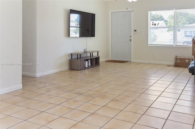 living room featuring ceiling fan and light tile patterned flooring