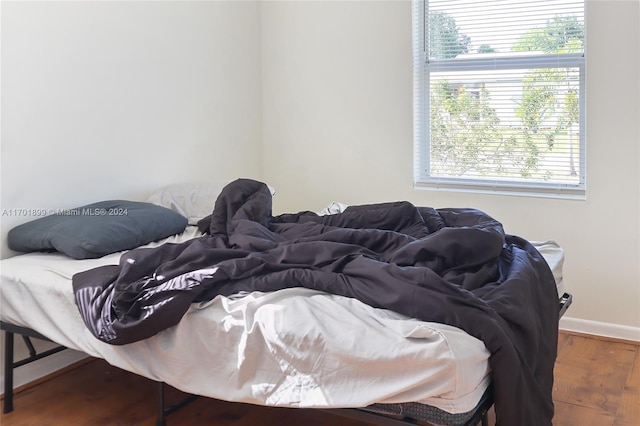 bedroom with hardwood / wood-style floors