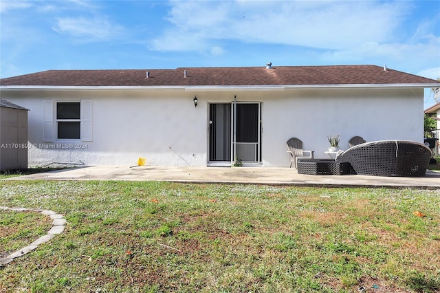 back of house with a lawn and a patio area